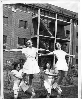 Women practicing tumbling behind Romney Gym