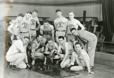 Basketball Team in Romney Gym posing for camera