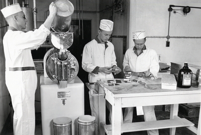 Three men making some type of snack during the Course in Dairy Industry, 1958/1959
