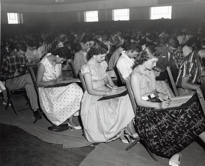 Students sit at desks during Freshman Week