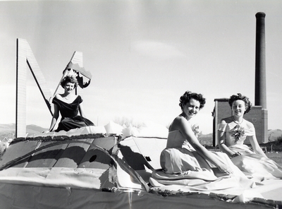 Homecoming royalty candidates riding a float during the homecoming parade, 1947