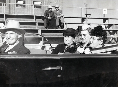 Three women in the back of a car for the homecoming parade, 1947