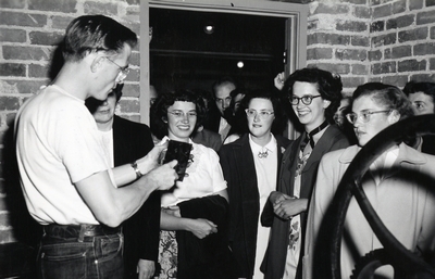 A group of students watch a demonstration