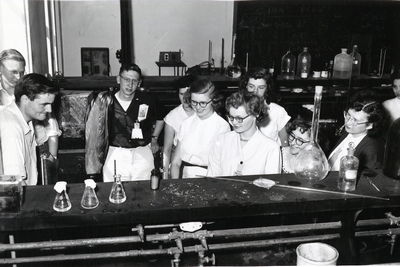 Students observe and conduct a chemical experiment.