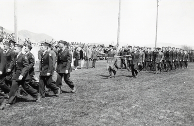 Members of ROTC march along the football field.