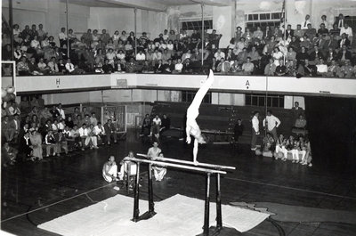 Men preform gymnastics in the Romney Gym