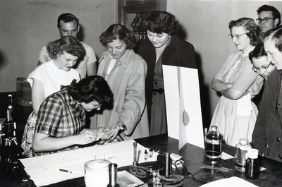 A group of students participate in the collection of fingerprints.