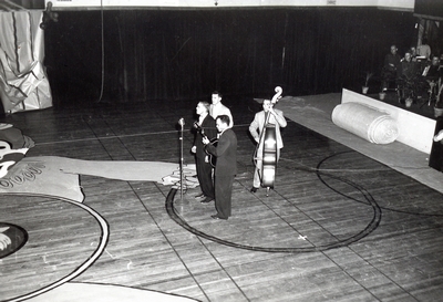 A small string band performs in the Romney Gym