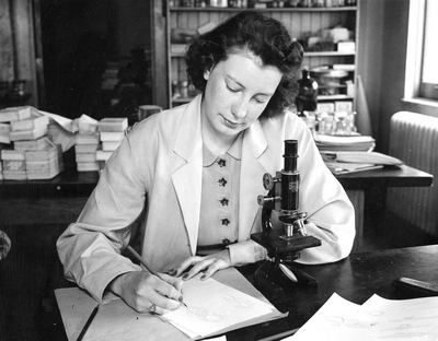 Woman using a microscope during High School Week
