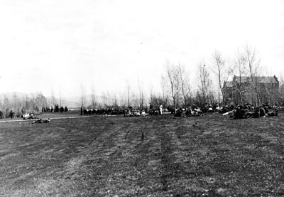 People sitting on the lawn at visitors day.