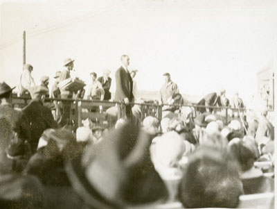 Man addressing a crowd from a flatcar of the Better Livestock Special Train