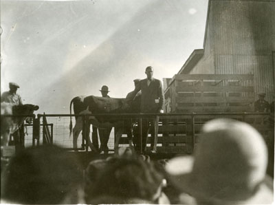 Man addressing a crowd from a flatcar of the Better Livestock Special Train