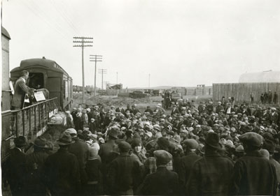 Man addressing a crowd from a flatcar of the Better Livestock Special Train