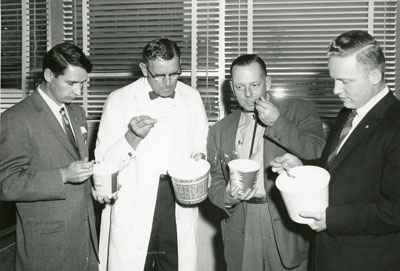 Small group of men tasting various dairy products at the Dairy Industry Short Course, 1957