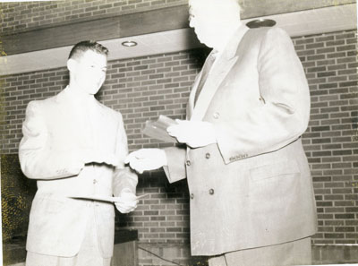 Two men, one receiving an award at the Dairy Industry Short Course