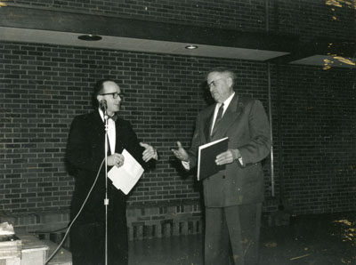 Two men on stage at the Dairy Industry Short Course