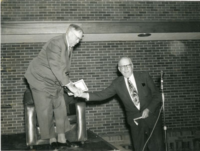 Two men shaking hands at the Dairy Industry Short Course