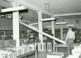 A man unloading boxes from the balcony collection, part of the Library Move 1949/1950