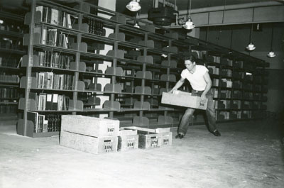 Man moving boxes for the library move 1949/1950