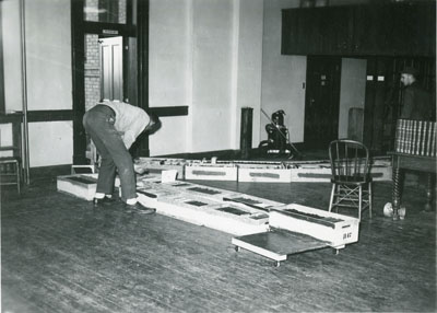 Man lining up moving boxes for the Library Move 1949/1950