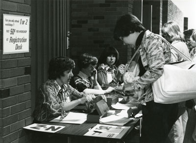 Conference registration desk, part of Focus on Women, 1976