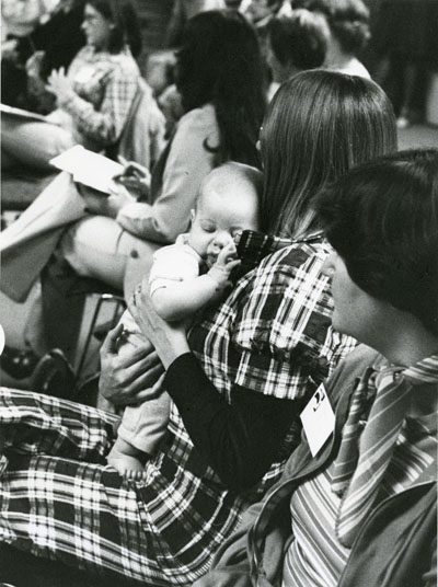 Audience, including a baby in its mothers arms at the Women Aware Conference.