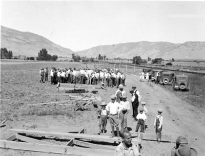 People gathered around for a farm demonstration.
