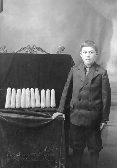 Boy standing in front of a Corn Exhibit