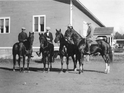 Four men riding horses at Montana State College