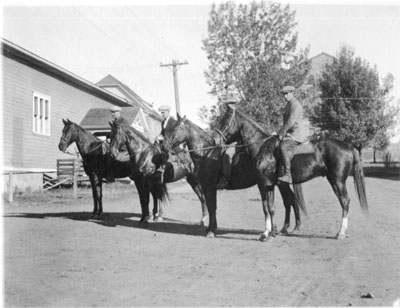 Four men riding horses.