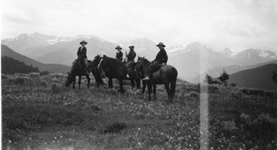 Harriette Cushman and three others riding horses