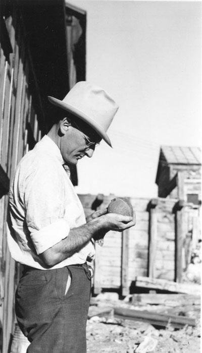 Man examining an unknown object in his hands