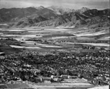 Aerial photo of the city of Bozeman with the Bridgers in the background and Montana State University in the foreground, taken from the south. 1953