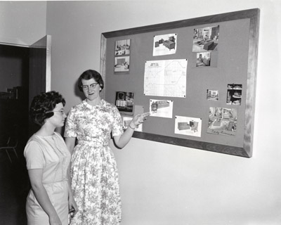 Sue Gentry and Mrs. Carolyn Dufner from Glendive, Montana look over a Display of Popular Furniture Styles
