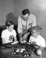 Ronnie Nansel and Bill Blum show The 4-H Leader, Donald Ochsner, Their Electric Projects