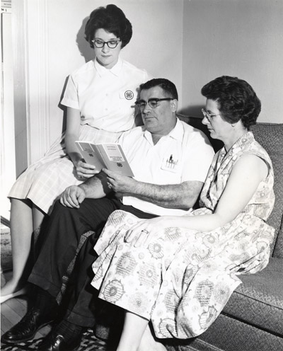 Sue Kosty Shows her Parents the Club Congress Souvenir Program