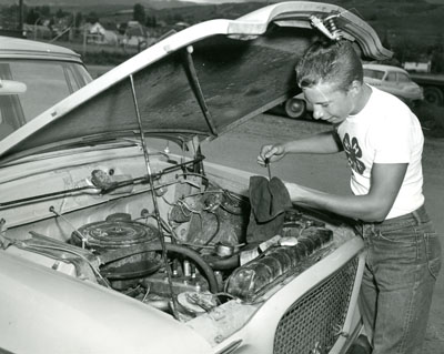 Ed Shipp from Silesia, Montana Checks the Oil Level in an Automobile