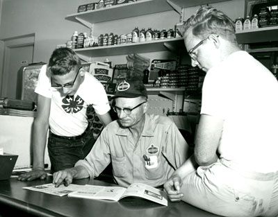 Thomas Miller, from Billings, Montana, Goes Over the 4-H Automotive Awards Leaflet with Dennis Bradshaw and Roy Day