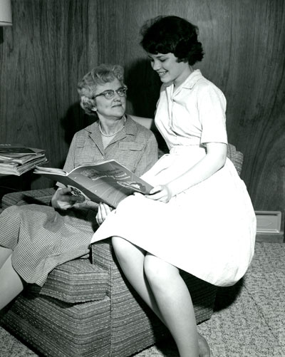 Alfreda Forswell and Patti Karr, Billings, Montana, Look Over the 1963 National 4-H Awards Handbook.