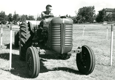 A Young Man Drives a Tractor