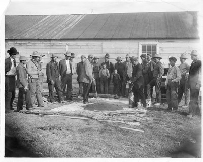M.L. Wilson demonstrating flax seed treatment