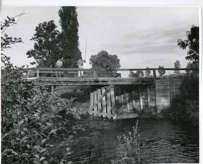 Two men fishing on bridge, 1959