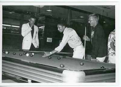 Three male 4-H students playing pool