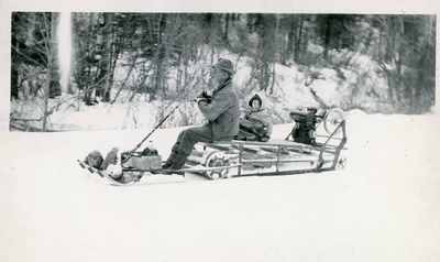 Man and child on snow-mobile at Hyalite Canyon, Spring 1945