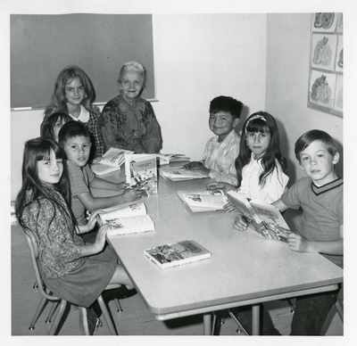 Student working with elementary school children