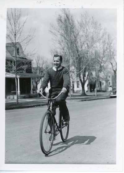 Roland R. Renne on bicycle