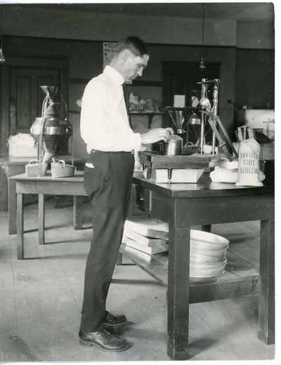 Man determining the test weight grain per bushel