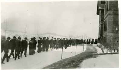 Students approaching north entrance of Montana Hall through the snow