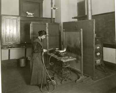 Woman working with welding torch in the art department