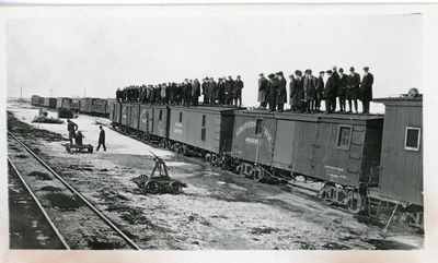 Group of students standing on train cars, 1916-1917